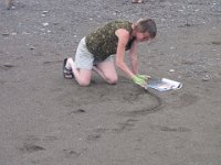 IMG 5109  Karin Bach, local artist starting the sand outline for Tidal Art Program, Alma Beach, Fundy National Park