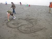 IMG 5125  Karin Bach, local artist starting the sand outline for Tidal Art Program, Alma Beach, Fundy National Park
