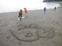 IMG 5126  Karin Bach, local artist starting the sand outline for Tidal Art Program, Alma Beach, Fundy National Park