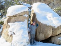 IMG_5287 Megan holding snow covered granite rocks apart, Hidden Valley Trail, Joshua Tree National Park