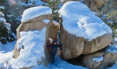 IMG_5288 Phelan holding snow covered granite boulders apart, Hidden Valley Trail, Joshua Tree National Park